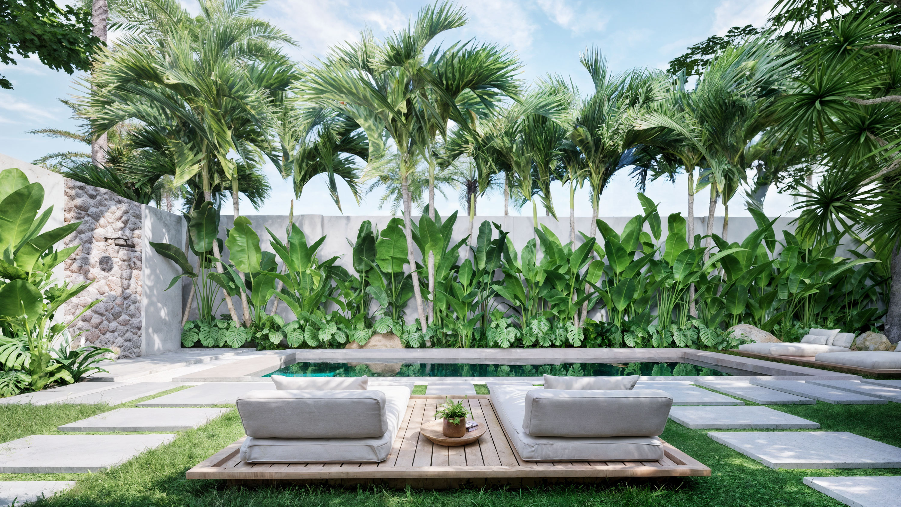 Pool with garden and stone wall backdrop